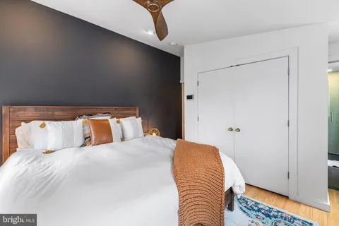 a bedroom with a bed and a night stand