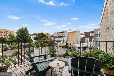 a view of a balcony with outdoor seating