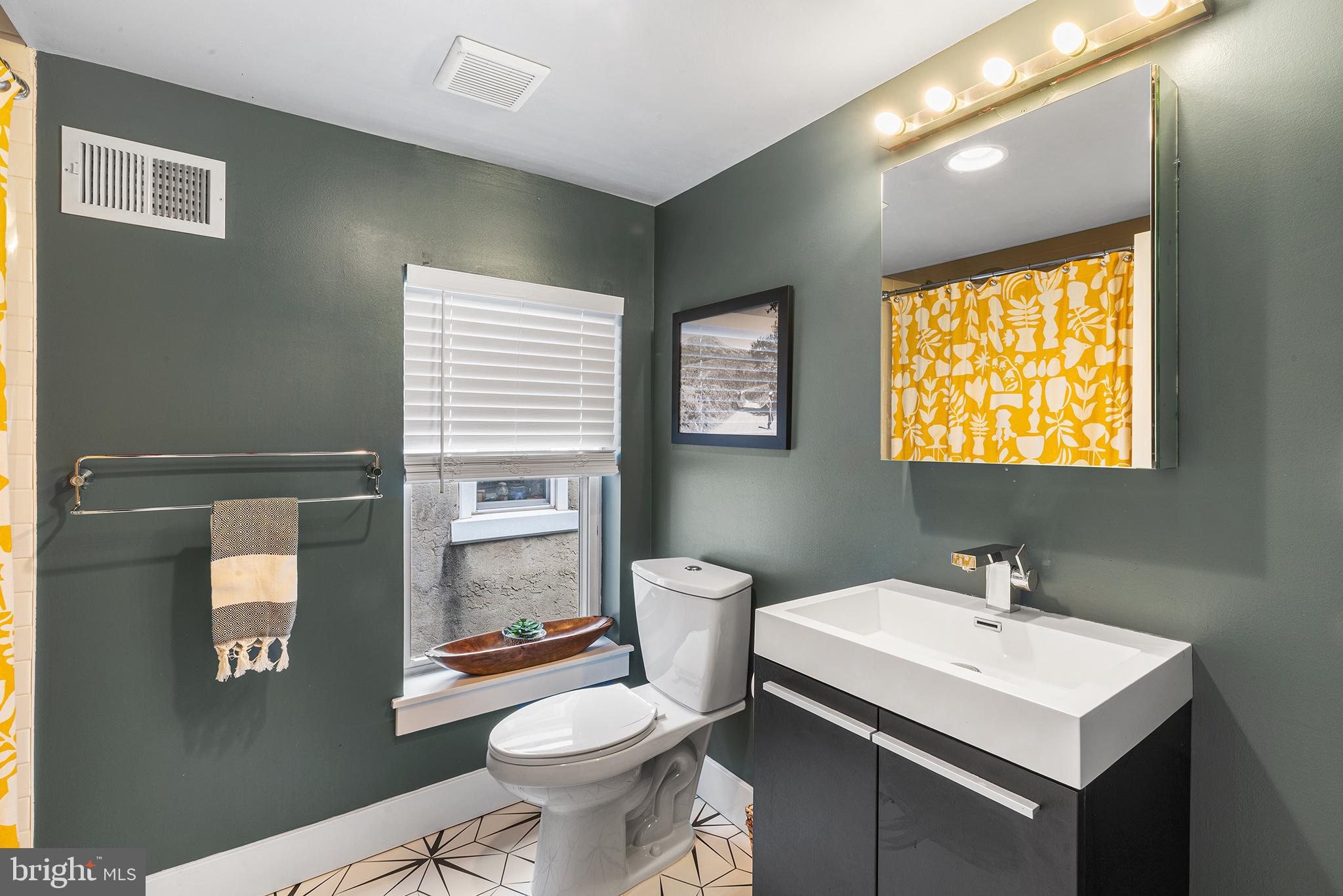 1337 Marlborough Street Philadelphia, PA 19125 - Photo 19 of 34 a bathroom with a sink toilet and mirror