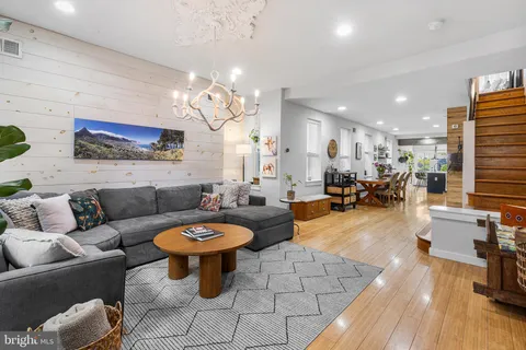 a living room with furniture a rug and a chandelier