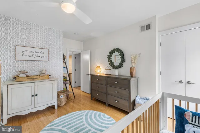 a view of bedroom with furniture and wooden floor