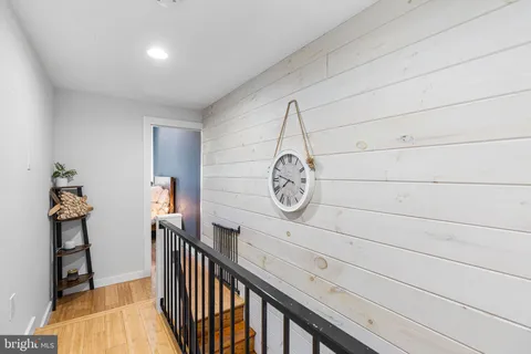 a view of a hallway with paintings on the wall