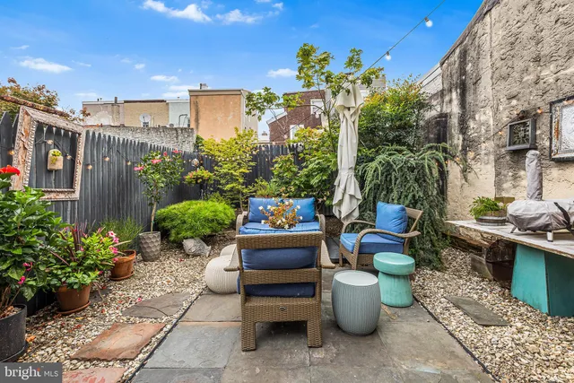 a view of a patio with couches and potted plants