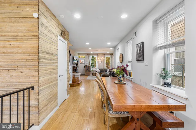 a dining room with furniture and wooden floor