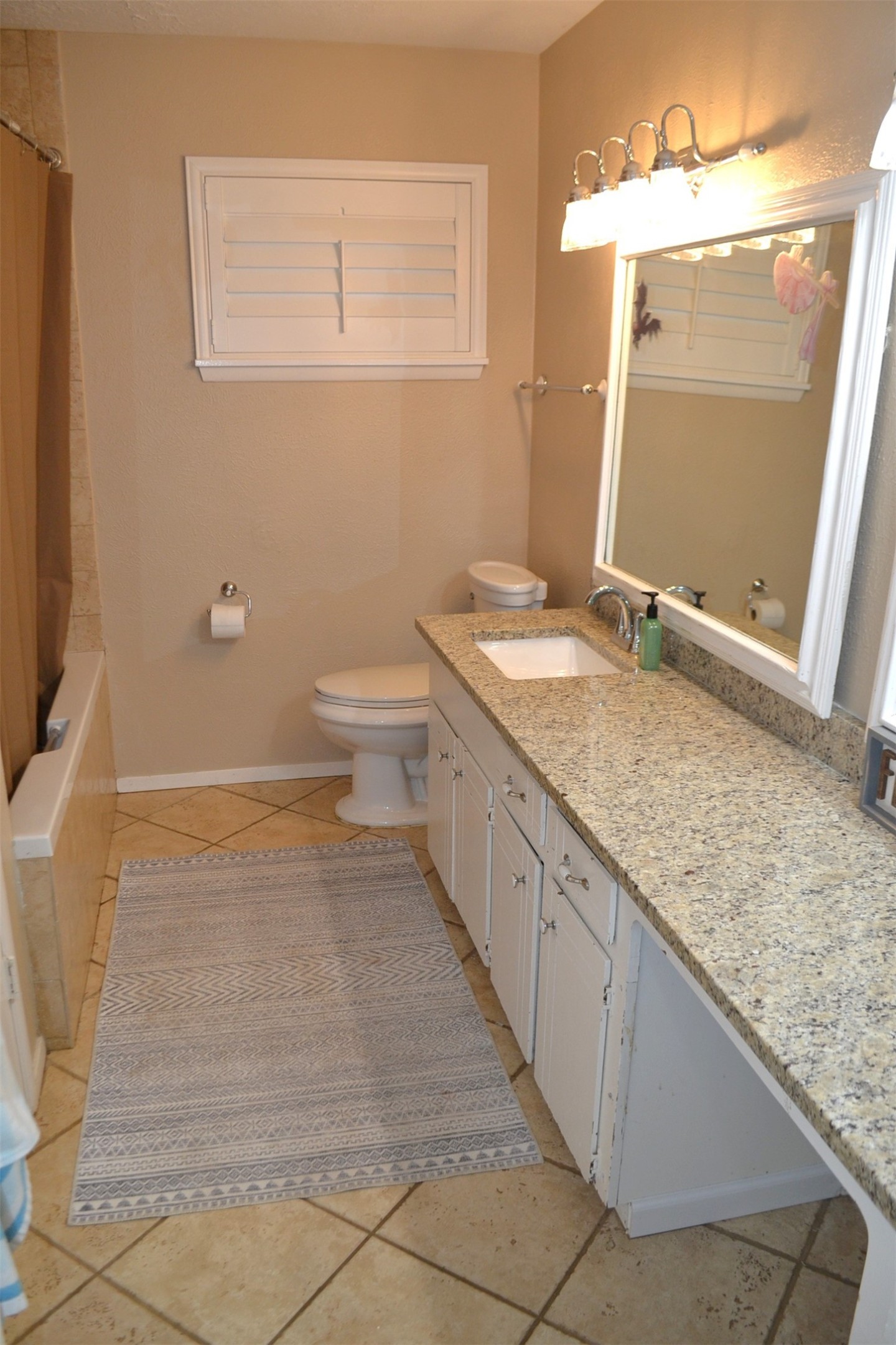 610 East X Street Deer Park, TX 77536 - Photo 26 of 44 a bathroom with a granite countertop sink and a mirror
