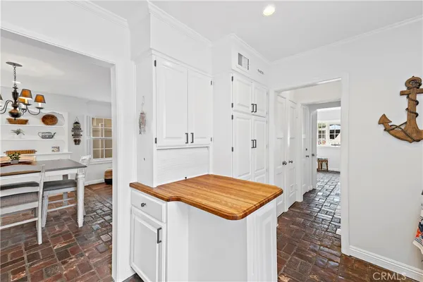 a view of kitchen island with cabinets and wooden floor