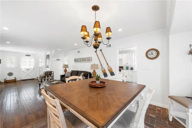 a room with table chairs and a chandelier
