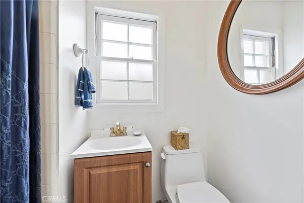 a bathroom with a toilet a sink and a mirror