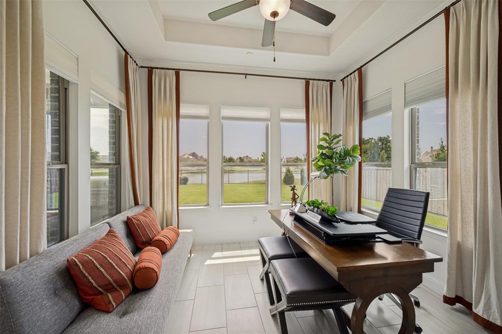 7821 Kentmere The Colony, TX 75056 - Photo 15 of 40 A versatile flex space bathed in natural light offers the perfect setting for a home office, sunroom, or cozy sitting area. Walls of windows frame stunning water views and overlook the oversized backyard, creating a bright, peaceful retreat ideal for work or relaxation.