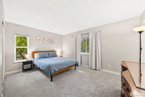 a spacious bedroom with a bed and a window