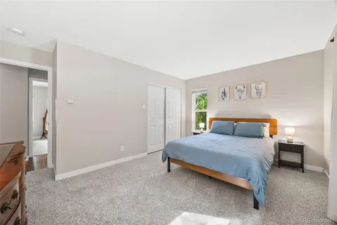 a bedroom with a bed and a lamp