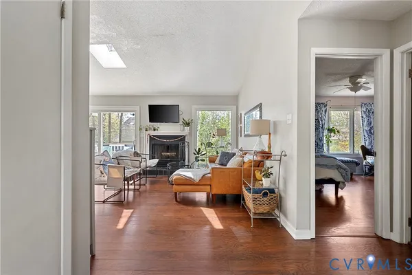 a living room with furniture fireplace and a large window