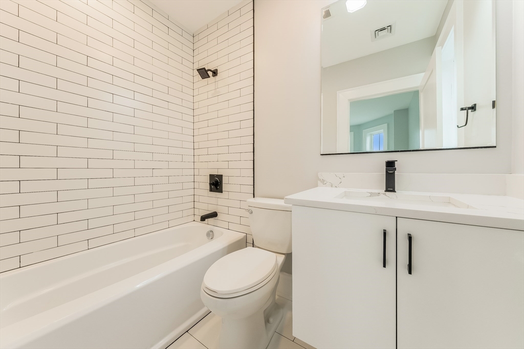 15 McKone Street, Unit 2 Boston, MA 02122 - Photo 12 of 24 a bathroom with a sink a toilet and shower