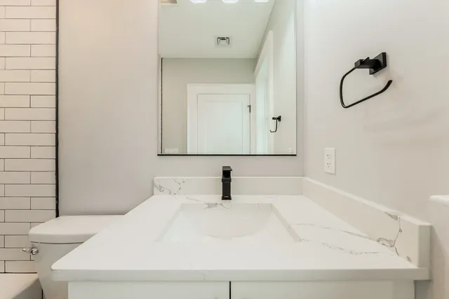 a bathroom with a shower and a glass door