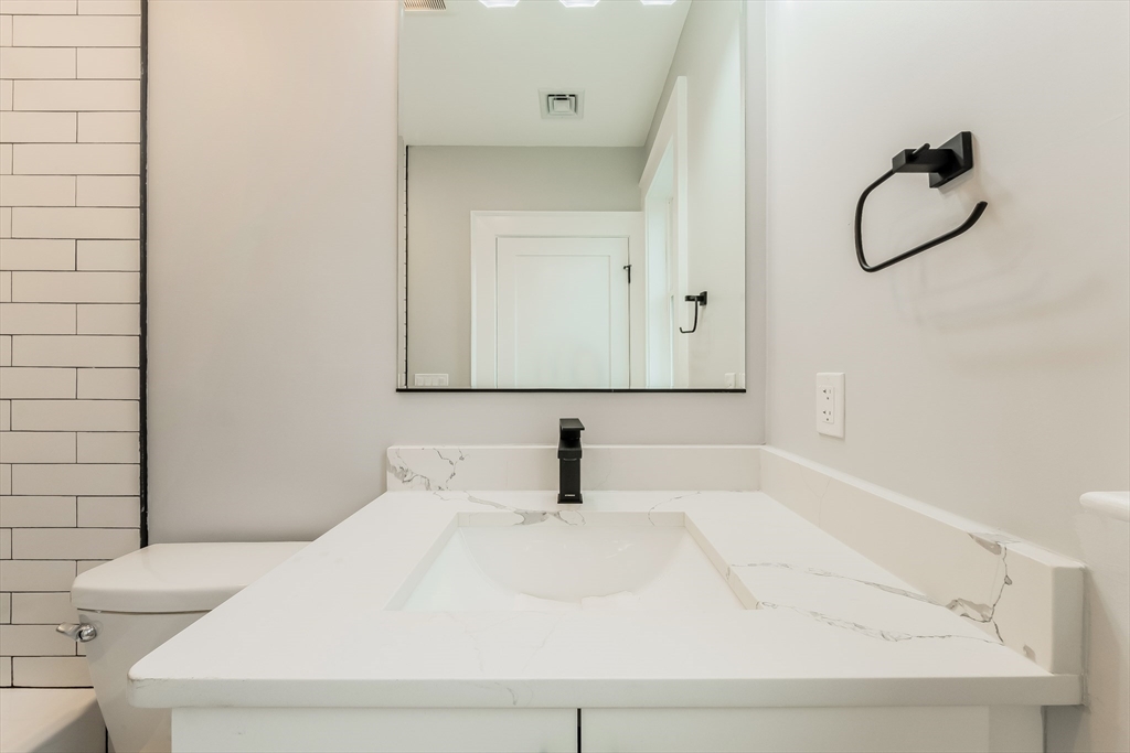 15 McKone Street, Unit 2 Boston, MA 02122 - Photo 13 of 24 a bathroom with a sink and a mirror