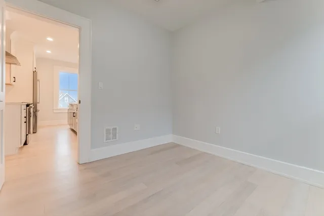 an empty room with wooden floor