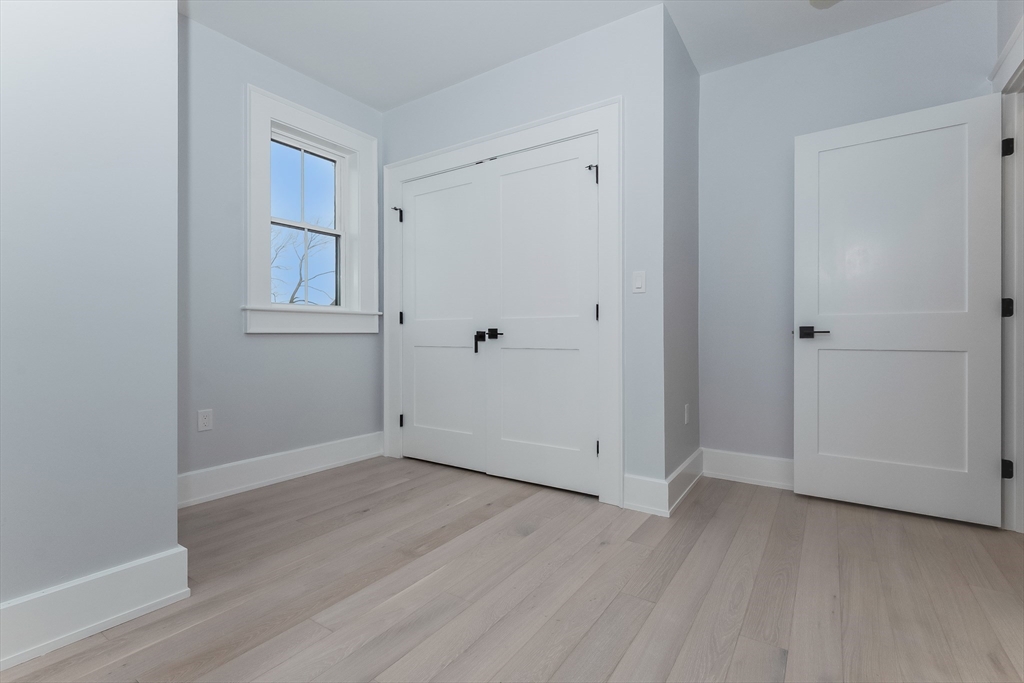15 McKone Street, Unit 2 Boston, MA 02122 - Photo 17 of 24 an empty room with wooden floor