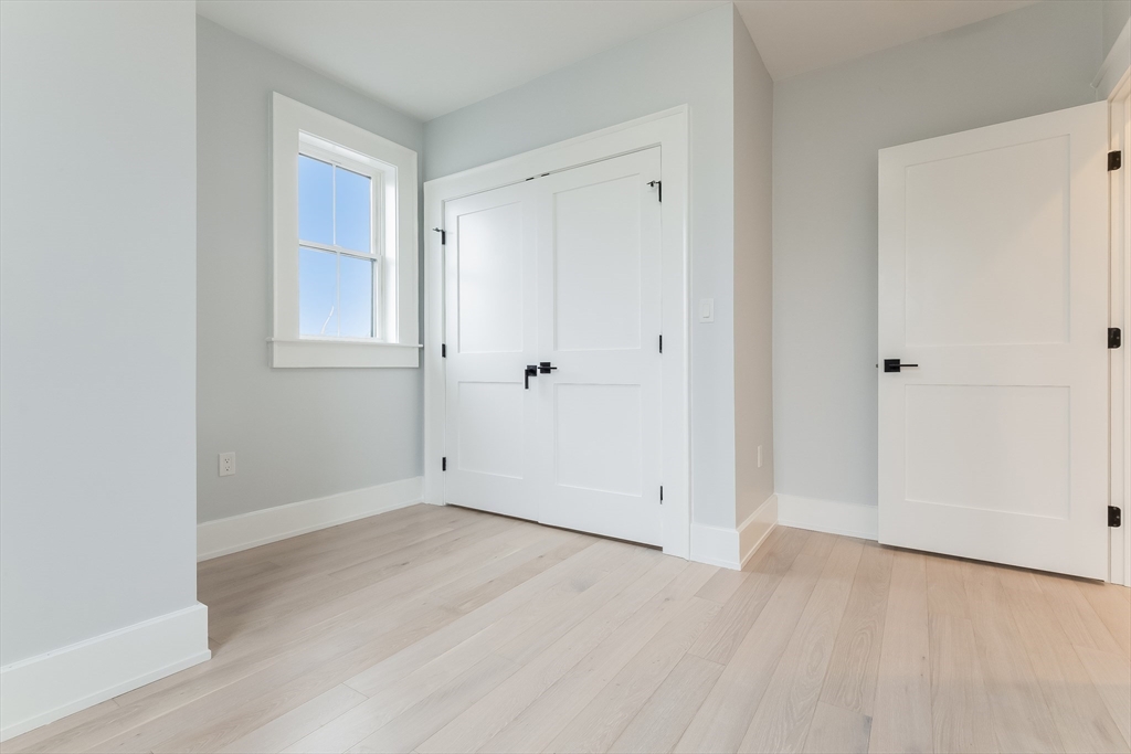 15 McKone Street, Unit 2 Boston, MA 02122 - Photo 18 of 24 an empty room with wooden floor