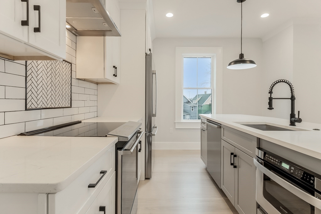 15 McKone Street, Unit 2 Boston, MA 02122 - Photo 2 of 24 a kitchen with a sink a stove and cabinets