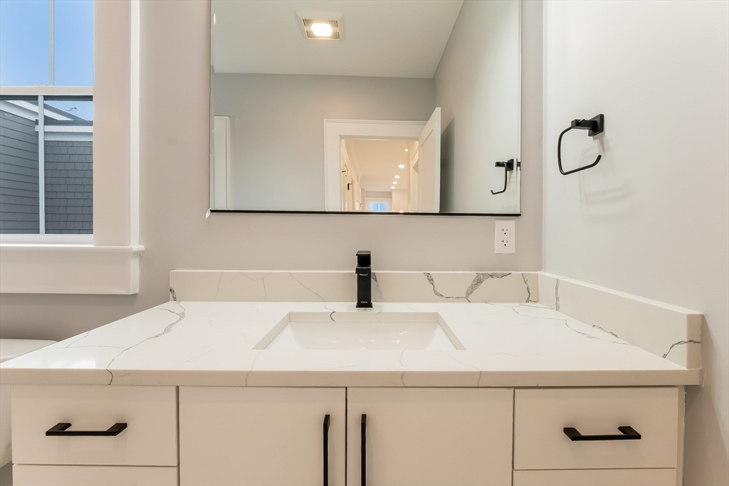 15 McKone Street, Unit 2 Boston, MA 02122 - Photo 21 of 24 a bathroom with a sink and a mirror
