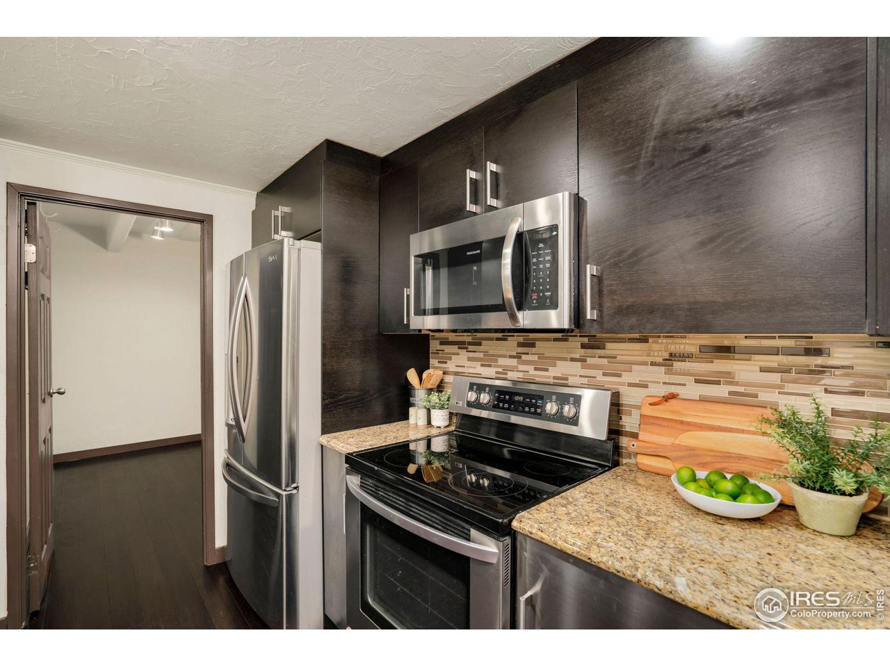 415 South Howes Street, Unit 910 Fort Collins, CO 80521 - Photo 11 of 28 a kitchen with kitchen island a stove and a refrigerator
