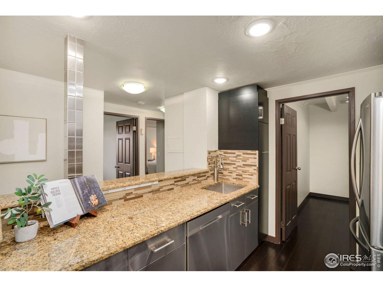 415 South Howes Street, Unit 910 Fort Collins, CO 80521 - Photo 12 of 28 a bathroom with a granite countertop sink a mirror and a shower