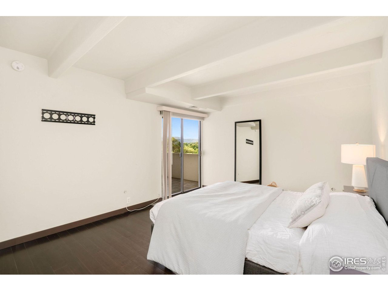 415 South Howes Street, Unit 910 Fort Collins, CO 80521 - Photo 14 of 28 a bedroom with a bed and painting on the wall