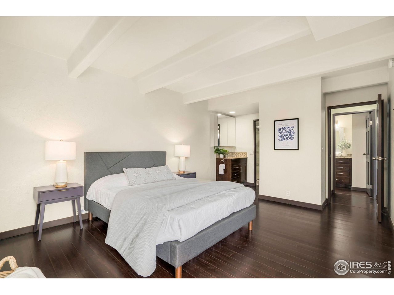 415 South Howes Street, Unit 910 Fort Collins, CO 80521 - Photo 15 of 28 a bedroom with a bed and wooden floor