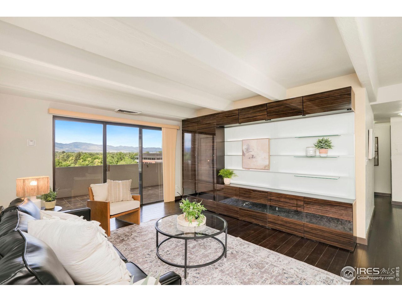 415 South Howes Street, Unit 910 Fort Collins, CO 80521 - Photo 7 of 28 a living room with furniture a large window and dining table