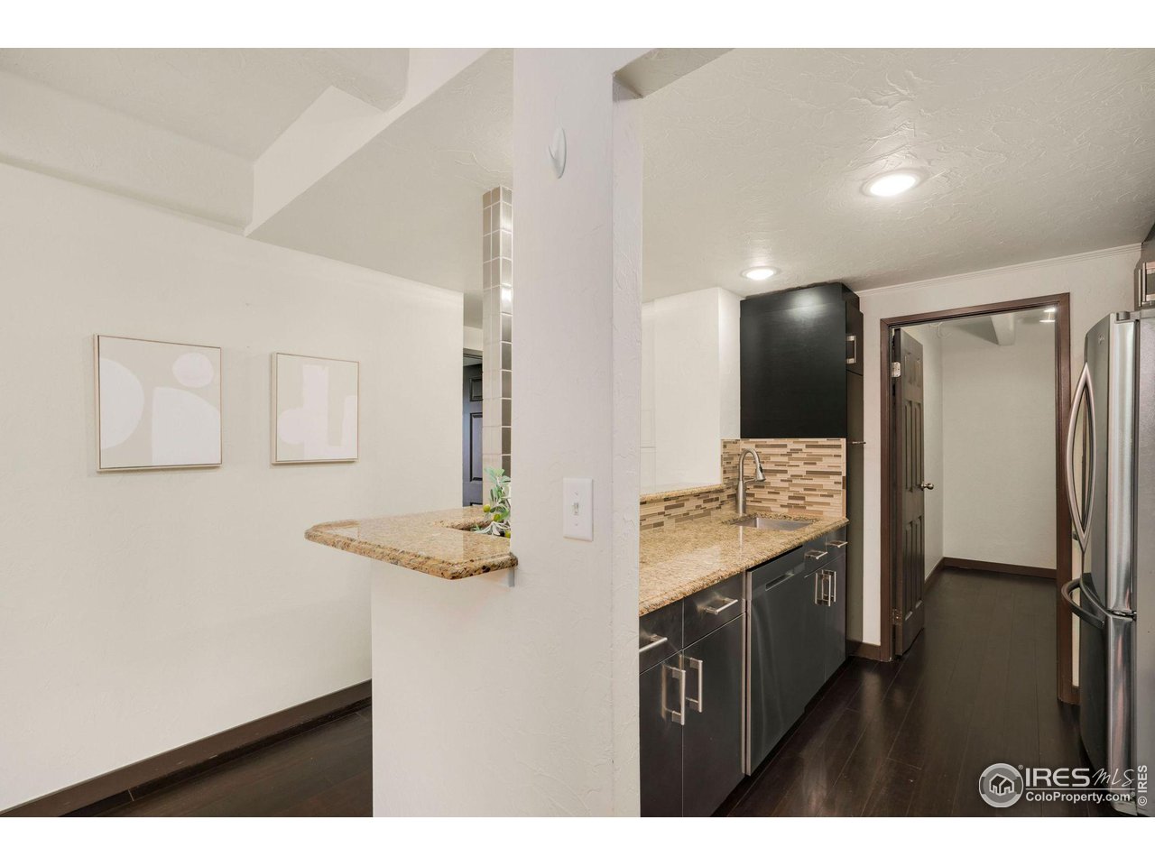 415 South Howes Street, Unit 910 Fort Collins, CO 80521 - Photo 9 of 28 a kitchen with stainless steel appliances cabinets and a counter top space