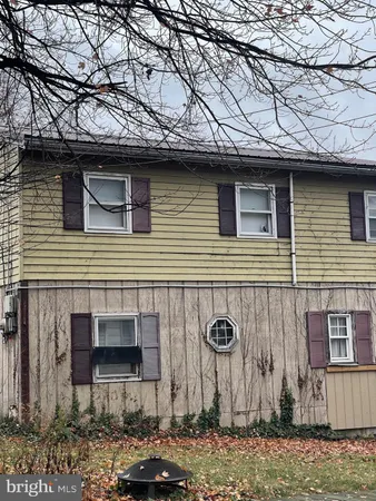 a front view of a house with parking area