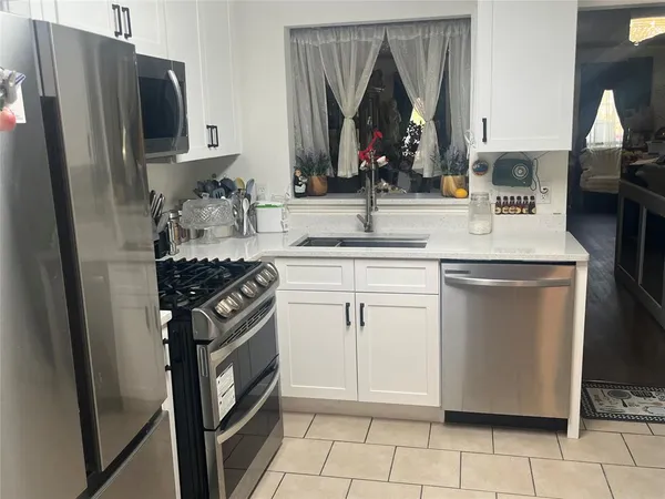 a kitchen with a sink stove and refrigerator