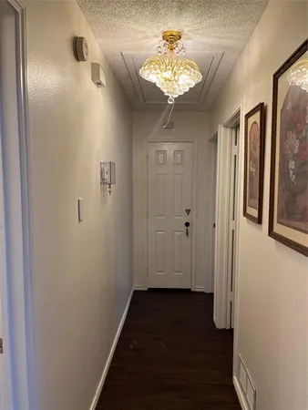 a view of a hallway with a chandelier