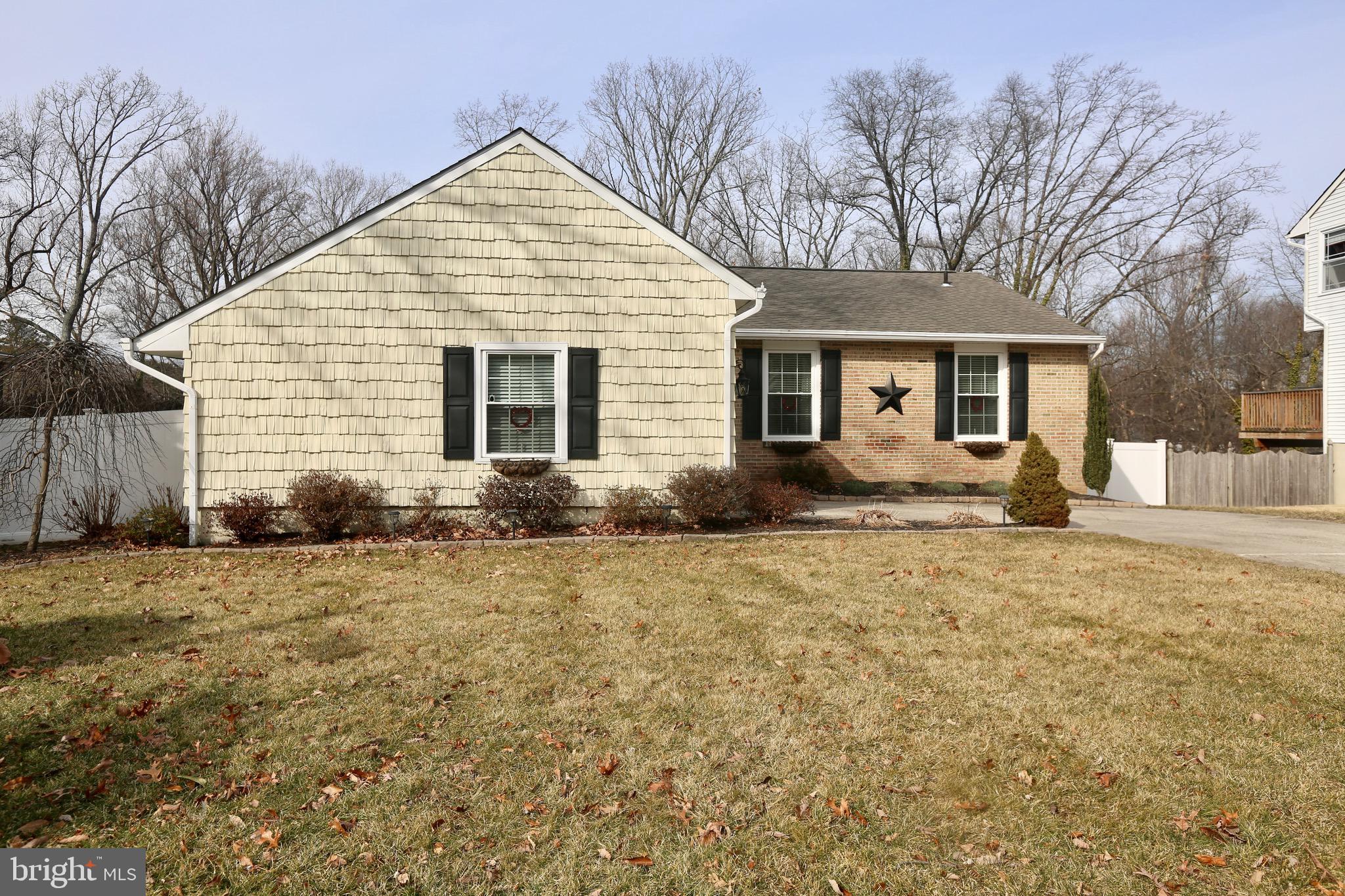 a view of a house with a yard covered in snow