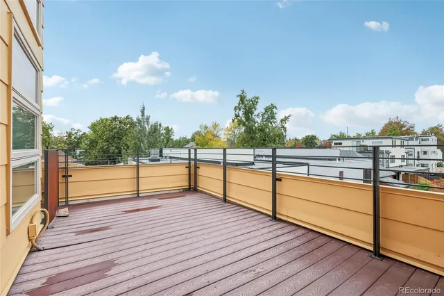 a view of a room with wooden floor and fence