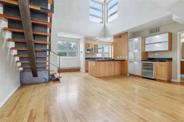 a view of a kitchen with cabinets and wooden floor