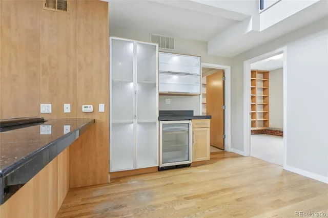 a kitchen with granite countertop a stove and a refrigerator