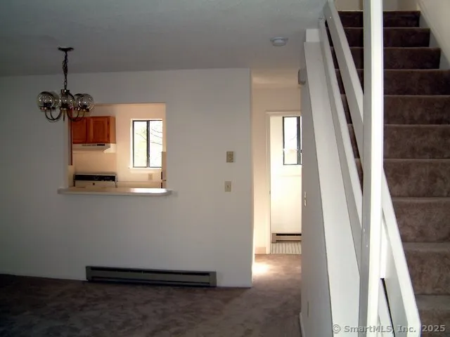 a view of an entryway with wooden floor and windows