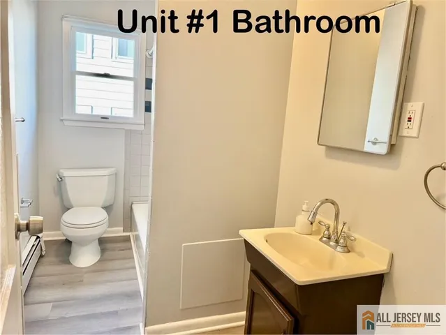 a bathroom with a sink a mirror and a toilet