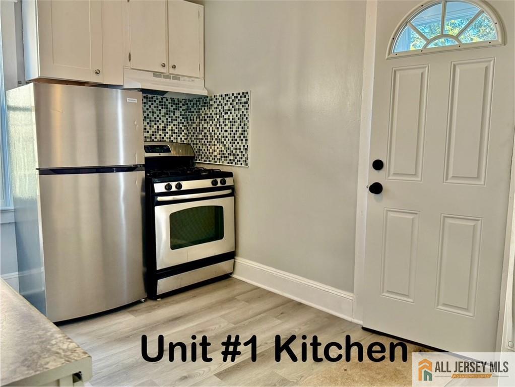 74 Andrew Street Hamilton, NJ 08610 - Photo 9 of 13 a kitchen with granite countertop white cabinets and refrigerator