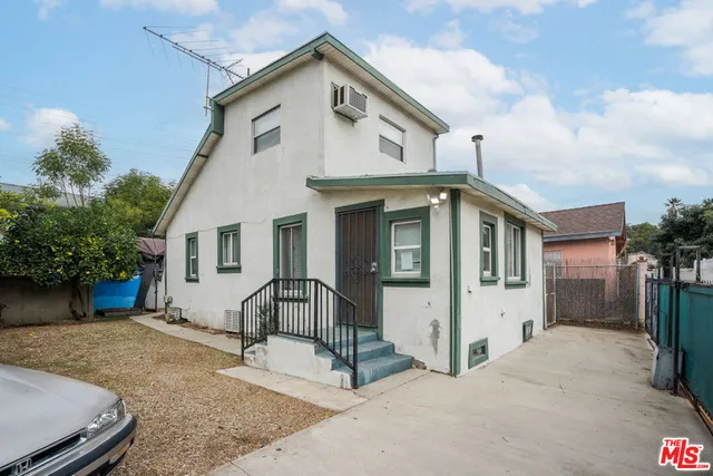 a view of a white house with large windows