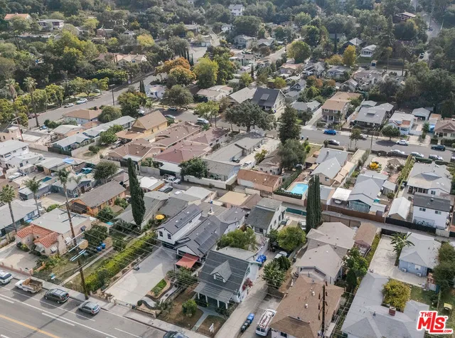 an aerial view of residential houses with outdoor space