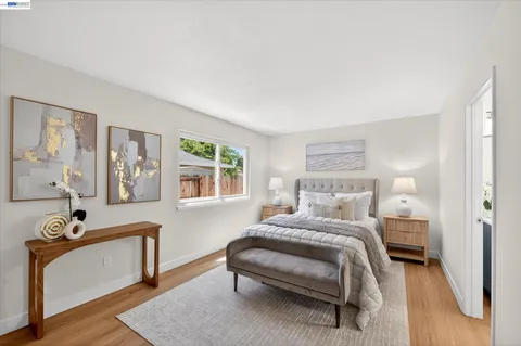 a bedroom with a bed and a night stand