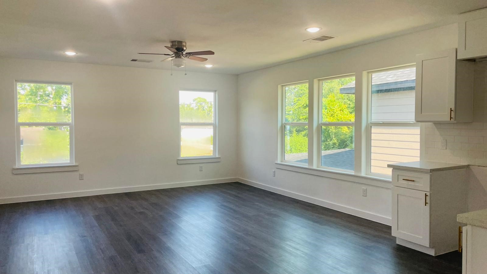 8414 Sandra Street, Unit A Houston, TX 77016 - Photo 3 of 14 a view of an empty room with wooden floor and a window