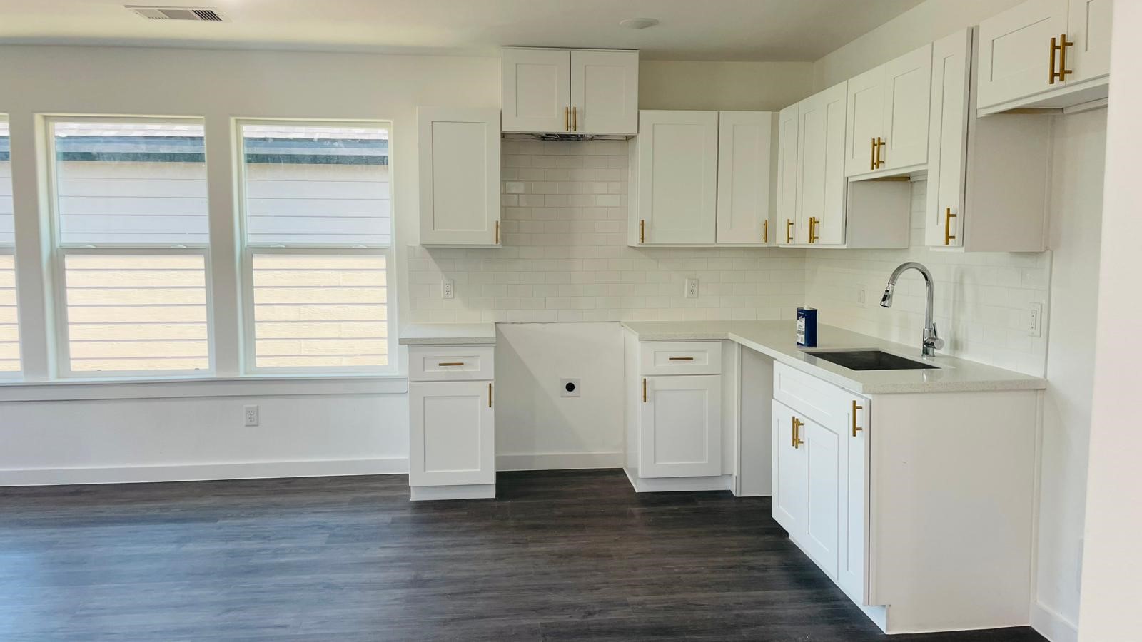 8414 Sandra Street, Unit A Houston, TX 77016 - Photo 4 of 14 a kitchen with white cabinets and wooden floor