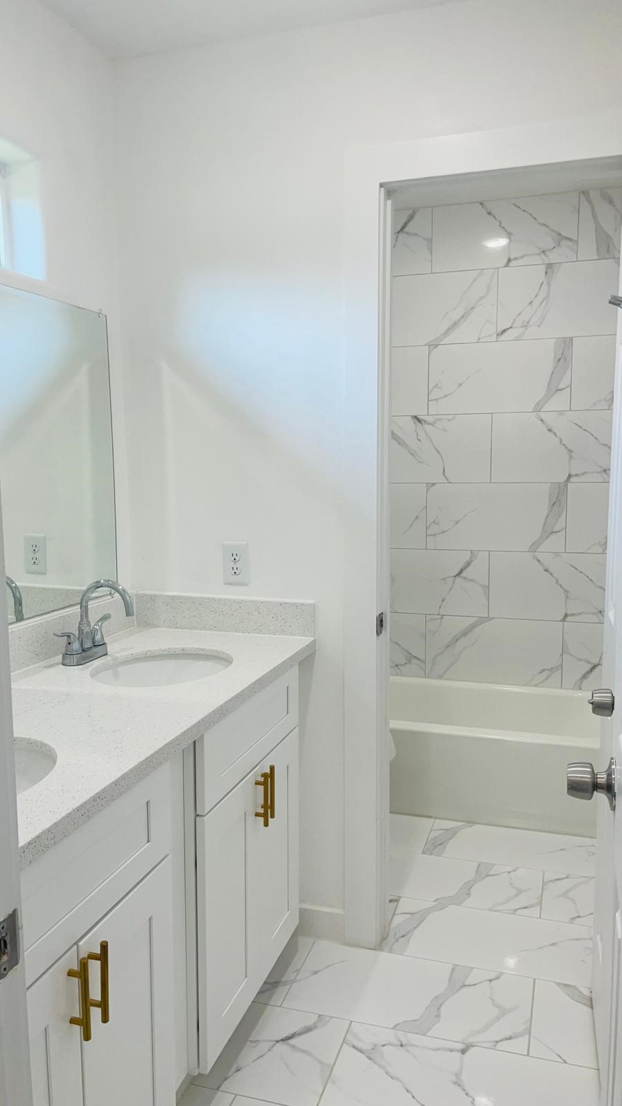 8414 Sandra Street, Unit A Houston, TX 77016 - Photo 9 of 14 a bathroom with a bathtub sink vanity and mirror