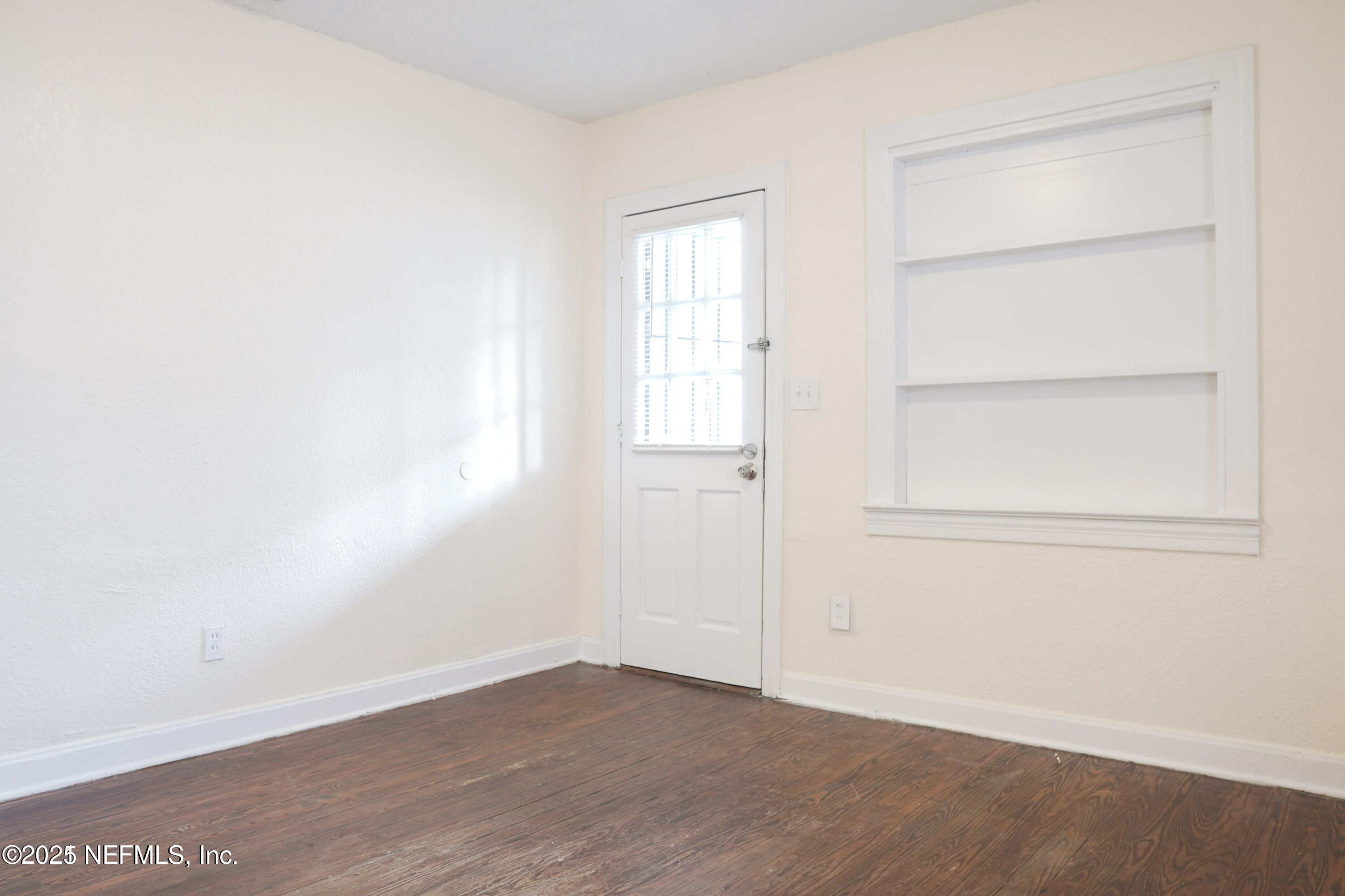 1473 State Street West Jacksonville, FL 32209 - Photo 2 of 12 a view of an empty room with wooden floor and closet