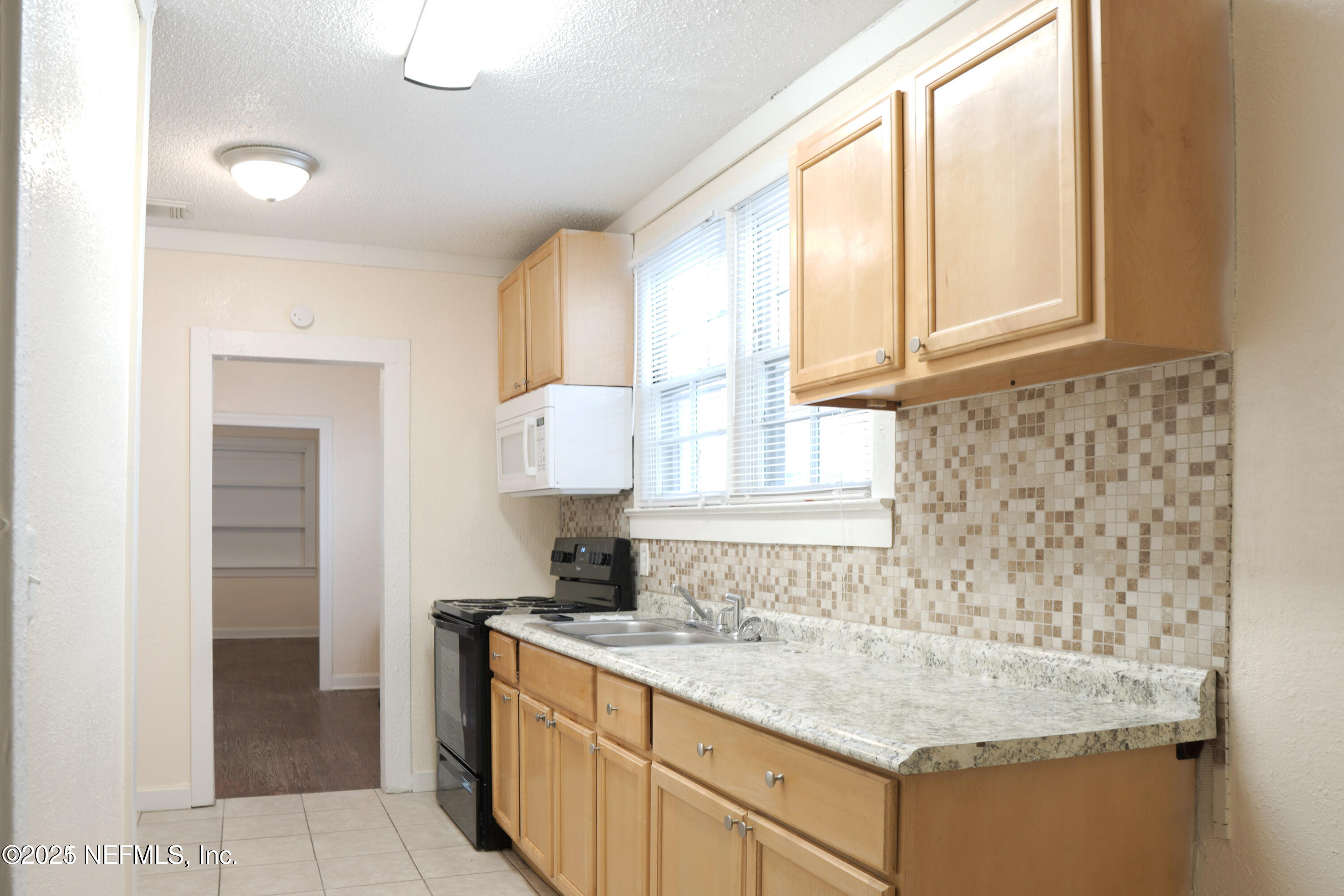 1473 State Street West Jacksonville, FL 32209 - Photo 3 of 12 a kitchen with granite countertop a sink and a stove