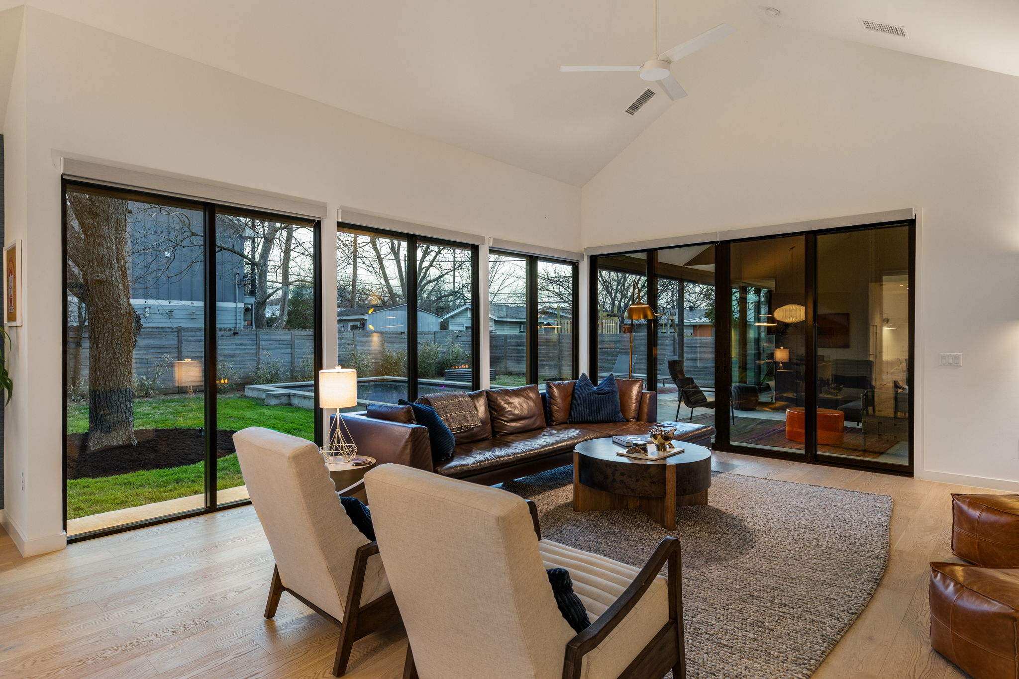 7502 St Louis Street Austin, TX 78757 - Photo 33 of 38 Sunroom / solarium featuring a high ceiling and wood finished floors