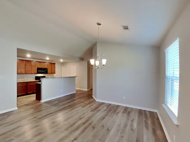a view of kitchen with sink and wooden floor